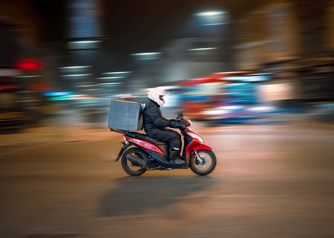 Photo by Rowan Freeman man riding motorcycle on road during daytime